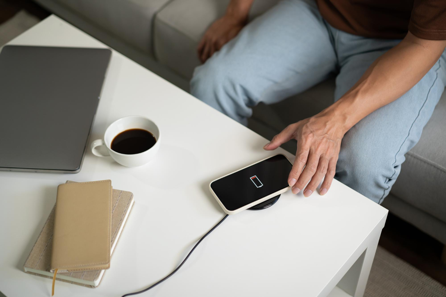 man places phone on wireless charger