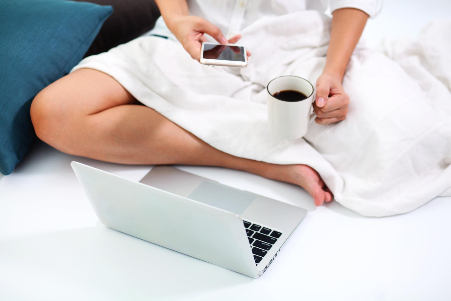 girl with a cup of coffee using a phone